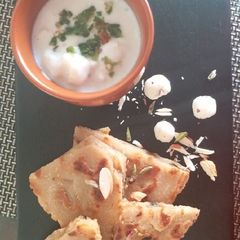 A picture of Falahari halwa paratha with makhane ka raita.