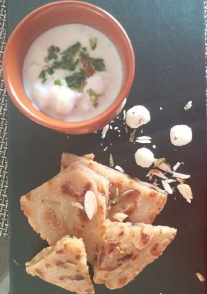A picture of Falahari halwa paratha with makhane ka raita.