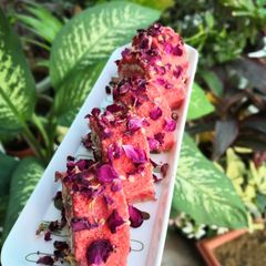 A picture of Rose and Coconut Flavor Swiss Roll with mava and Gulkand Filling.