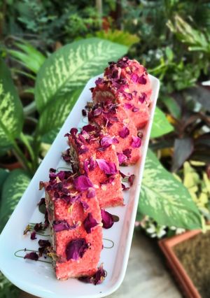 A picture of Rose and Coconut Flavor Swiss Roll with mava and Gulkand Filling.