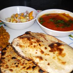 A picture of Lauki Roti(tandoori) with aloo tamatar, karela and salad.