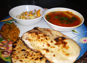 A picture of Lauki Roti(tandoori) with aloo tamatar, karela and salad.
