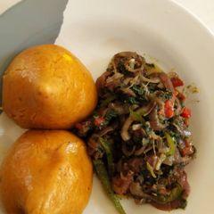 A picture of Moi moi and spinach sauce.