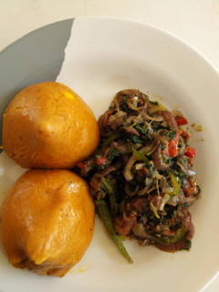 A picture of Moi moi and spinach sauce.