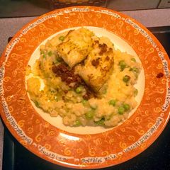A picture of Cod topped pea Risotto.