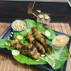 A picture of Thai chicken satay with peanut butter sauce.
