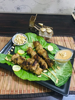A picture of Thai chicken satay with peanut butter sauce.