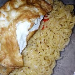 A picture of Noodles and fried egg.