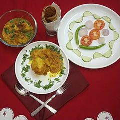 A picture of Paneer stuffed potatoes in masala gravy.