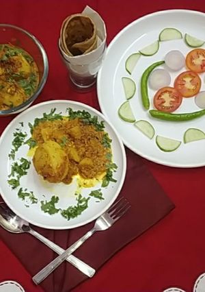 A picture of Paneer stuffed potatoes in masala gravy.