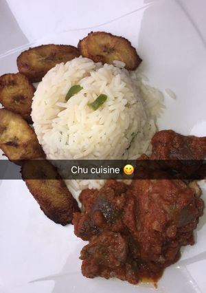 A picture of White rice, meaty tomato stew and fried plantain.