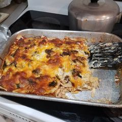 A picture of Chicken, spinach & mushroom Alfredo lasagna.