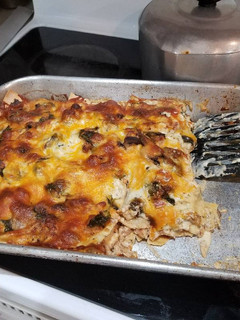 A picture of Chicken, spinach & mushroom Alfredo lasagna.