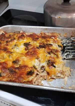 A picture of Chicken, spinach & mushroom Alfredo lasagna.