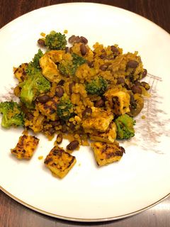 A picture of Cauliflower Yellow Rice with Black Bean,Tofu,and Broccoli 🥦.