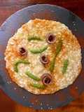 Risotto ai porri con acciughe del Cantabrico, pesto di rucola e lime