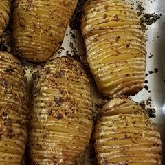 A picture of Small garlic and herb hasselback potatoes.