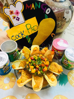 A picture of Fresh mango 🥭 salsa with prinkles(chips).