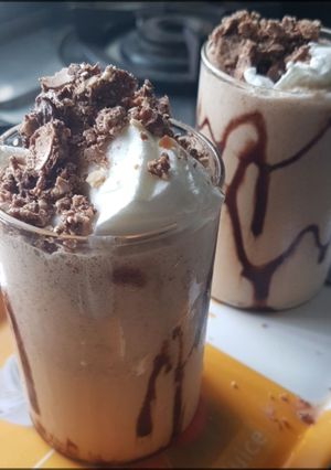 A picture of Cold coffee with crumbled Ferrero Rocher.