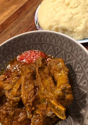 A picture of Lamb / Beef in Palm creme sauce with FuFu.