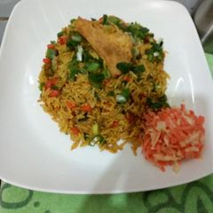 A picture of Fried rice with side coleslaw.