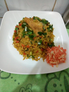 A picture of Fried rice with side coleslaw.