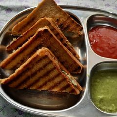 A picture of Brown bread Potato stuff peanuts butter grilled sandwich.