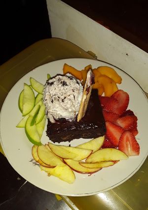 Una foto de Brownie con helado en aro de frutas