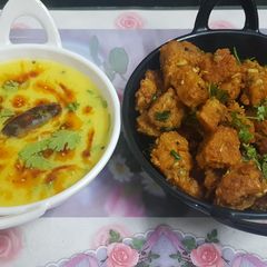 A picture of Lauki muthiya with spicy curry.