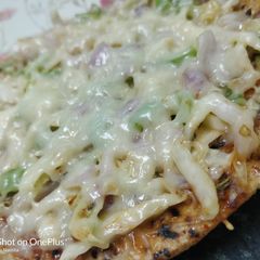 A picture of Leftover roti pizza.