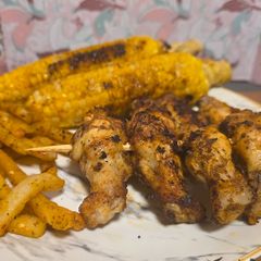 A picture of Grilled chicken drumettes skewers.