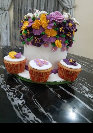 A picture of Butter Cake Covered in fondant With Royal icing flowers.