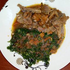 A picture of Goat Meat Stew with Sukuma Wiki.