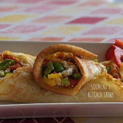A picture of Moong Dal Pancake with stuffed Paneer and colourful Bell Peppers.