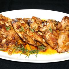 A picture of Roasted chicken thighs with fresh rosemary.