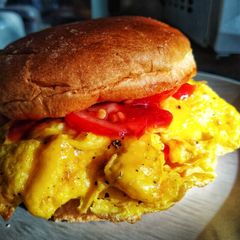 A picture of Folded Egg, Tomato & Cheese Breakfast Bap.