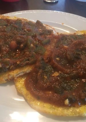 A picture of Huevos Rancheros w/tortilla.