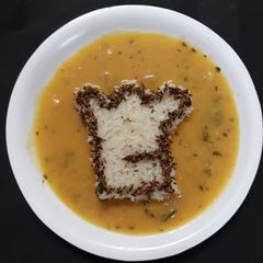 A picture of Jeera rice with dal fry.