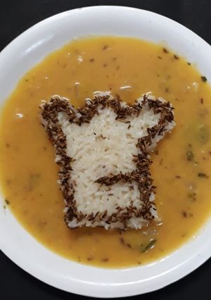 A picture of Jeera rice with dal fry.