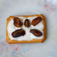 A picture of Tuc with fresh cream and date.