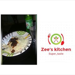 A picture of White superghetti with palm oil sauce nd boiled egg.