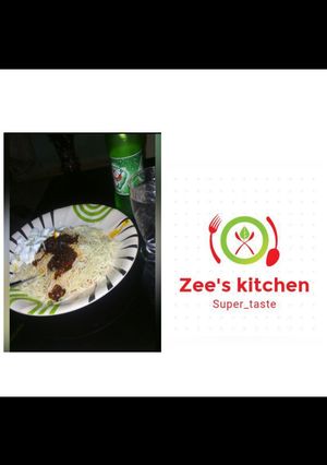 A picture of White superghetti with palm oil sauce nd boiled egg.