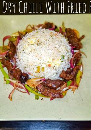 A picture of Beef Dry Chilli With Fried Rice.