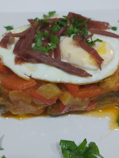 Una foto de Tarta de pisto, base de patatas, con huevos y tiritas de jamón