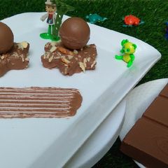 A picture of Chocolate kaju katli with surprising chocolates sphere.