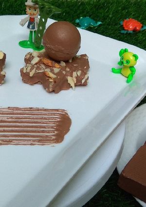 A picture of Chocolate kaju katli with surprising chocolates sphere.