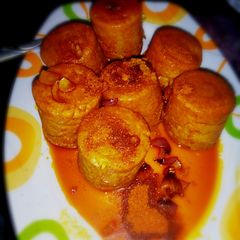 A picture of Moi Moi coated with palm oil nd ground pepper (yaji).