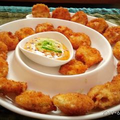 A picture of Fried Pickles with honey mustard dipping sauce.
