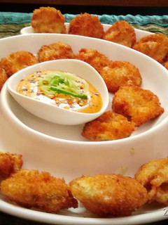 A picture of Fried Pickles with honey mustard dipping sauce.