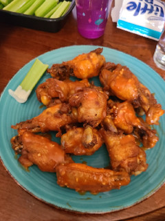 A picture of Buffalo garlic chicken wings.